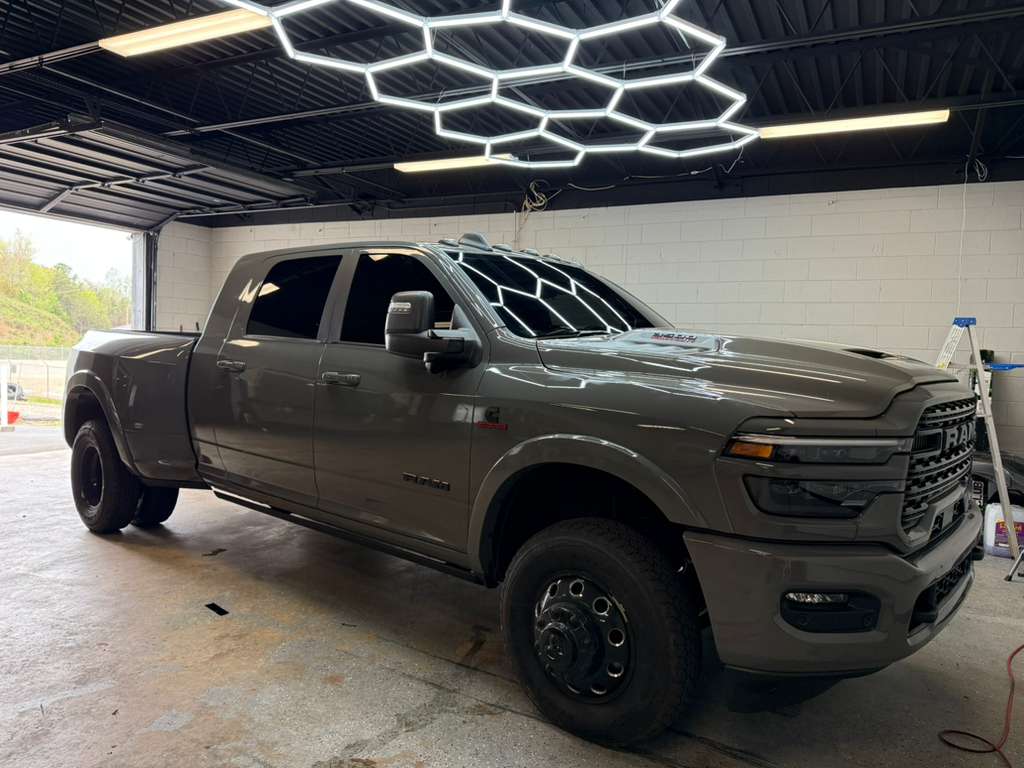 Grey Ram 3500 dually with fresh window tint under hex lighting at TINT WORXZ